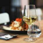 professional bartender using classic wine glass in cocktail bar