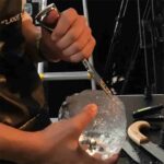 Bartender Using Heavy Duty 3-Prong Ice Pick to Fracture Ice Blocks in Professional Bar