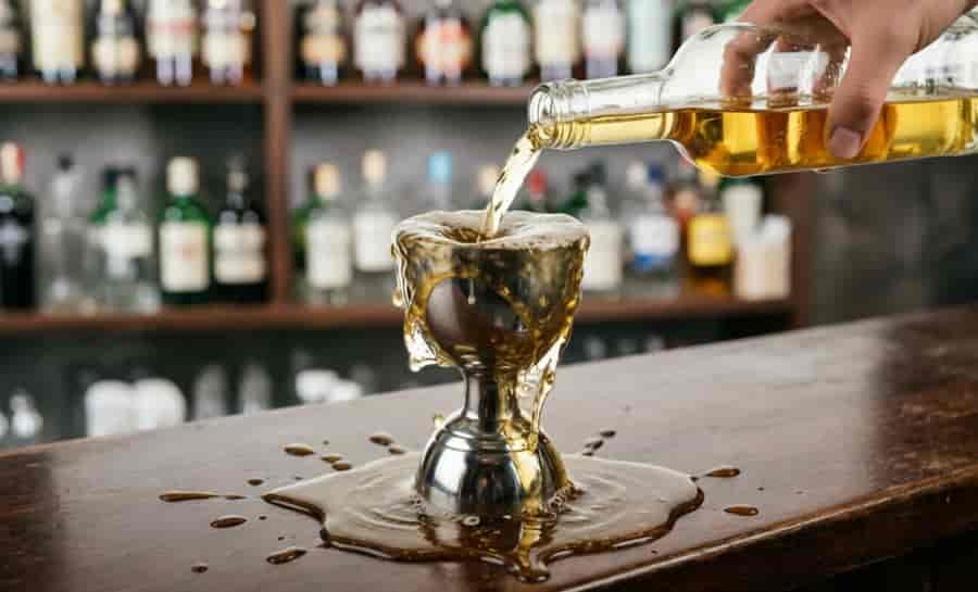jigger surface tension overfill common mistakes bartender technique cocktail measuring